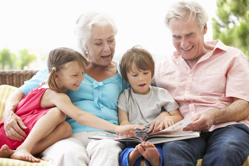 grandparents and grandchildren reading book 
